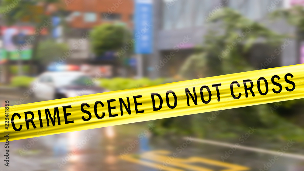 Obraz premium Boundary Tape and defocused squad car at Crime scene