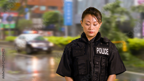 Fotografie Asian American Woman Police Officer looking down