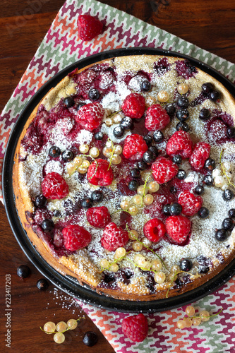 A Dutch baby pancake with fresh fruits (raspberries and currants)