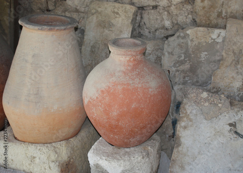 Clay jugs on the background of a stone wall.