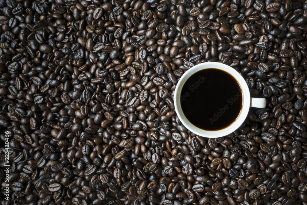 Black coffee above roasted coffee beans Black coffee above roasted coffee beans