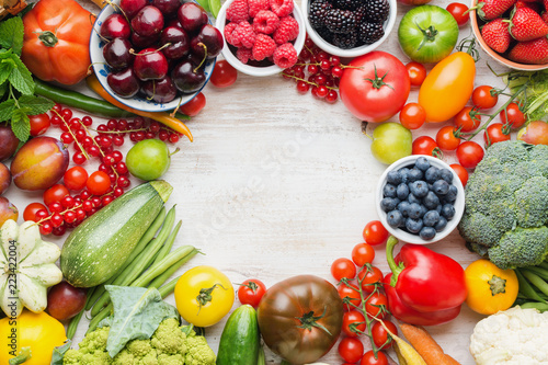 Fototapeta Naklejka Na Ścianę i Meble -  Healthy summer fruits vegetables berries arranged in a circle frame, cherries peaches strawberries cabbage broccoli cauliflower squash tomatoes carrots beetroot, copy space, top view, selective focus