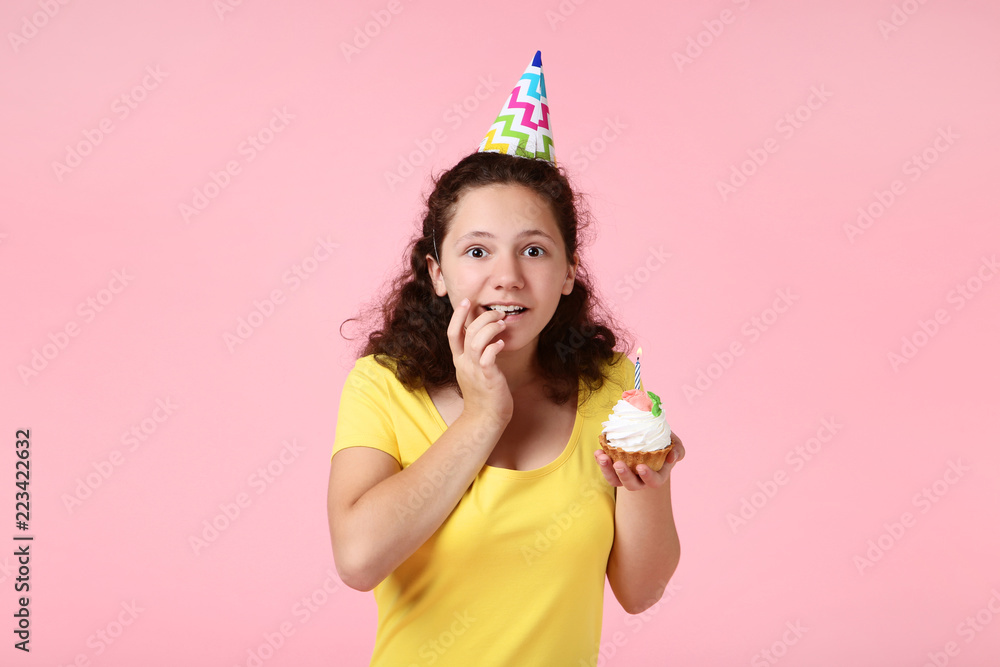Beautiful young girl with cupcake on pink background Beautiful young girl with cupcake on pink background