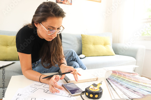 A young woman architect and an interior designer preparing a plan