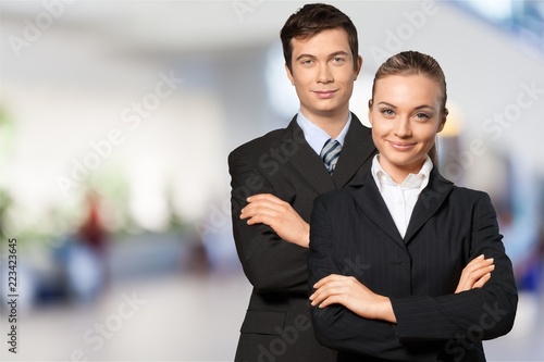 Young business couple in black suits in