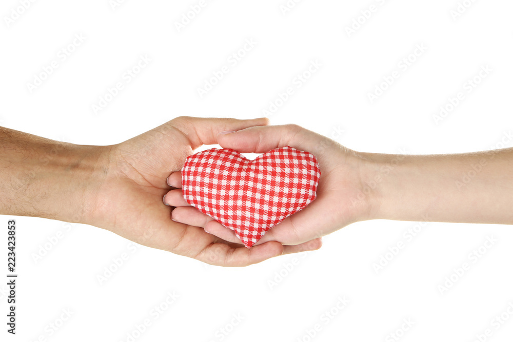 Obraz premium Female and male hand holding red fabric heart on white background