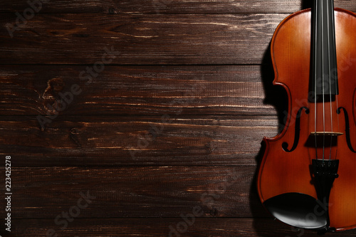 Violin on brown wooden table © 5second