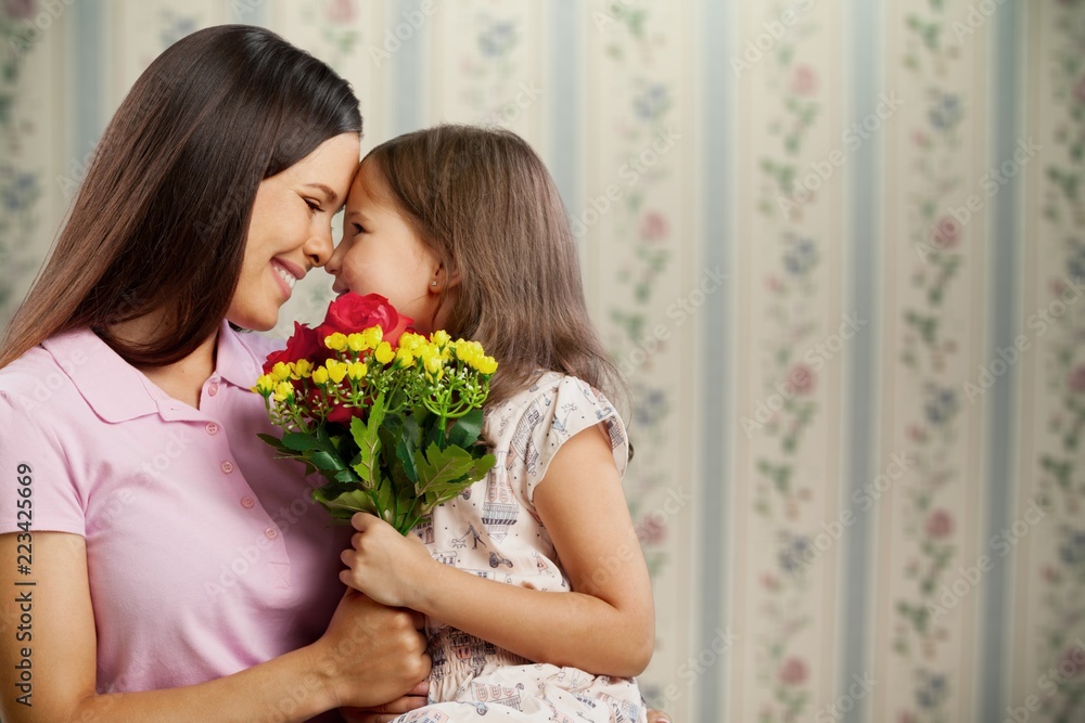 Happy Mother and daughter hugging with flowers Happy Mother and daughter hugging with flowers