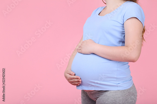Pregnant woman on pink background