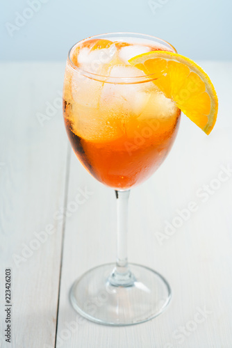 Aperol Spritz served with an orange slice in wine glass. White background, high resolution