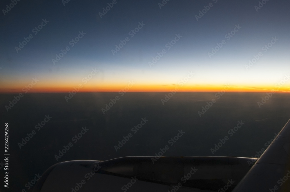 Looking at the sunrise from an airplane window