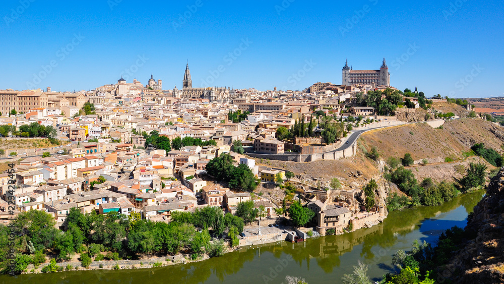 Panoramic view of the center of Toledo with the Tajo (Tagus) river, Alcazar and tower of Toledo Cathedral. Toledo is a medieval town and a former capital of Spain
