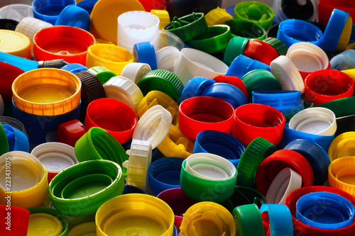 Secondary raw material. Macro image of multi-colored caps from bottles, an excellent raw material for recycling.