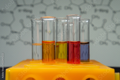 Canvas Print test tubes with colored fluids in a chemistry laboratory - structural formula in