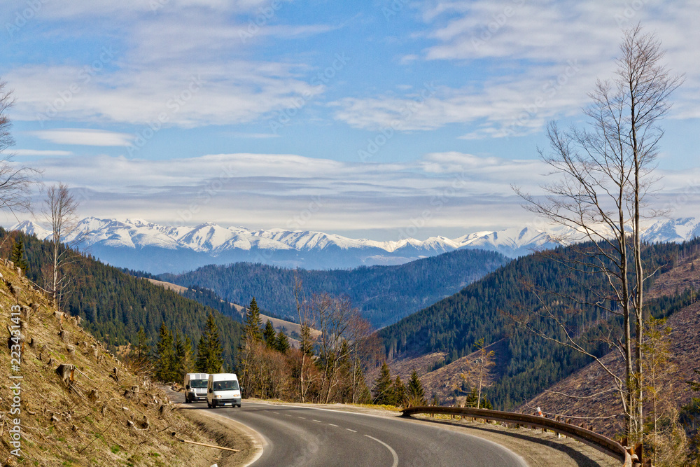 Fototapeta premium Two vans on a winding mountain road