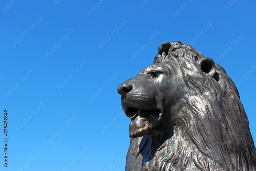 Bronze lion statue and clear blue sky in the background Bronze lion statue and clear blue sky in the background