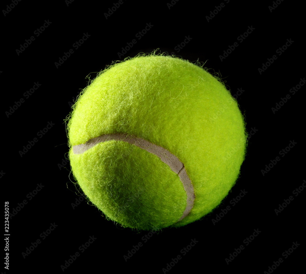 New tennis ball isolated on black background
