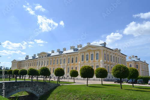 Great beautiful palace with trees and grass under the sky