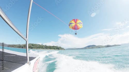 People parasail behind boat in Australia, POV