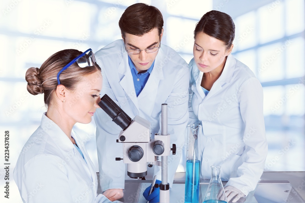 Female and male scientists in glasses working Female and male scientists in glasses working