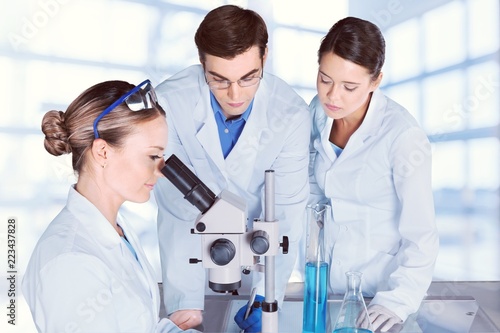 Female and male scientists in glasses working