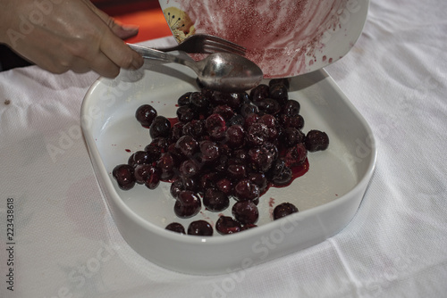 Clafoutis with Cherry. Red and ripe cherries. Preparation and close-up.