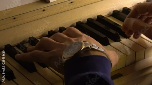 Pianist plays the piano. Hands clousup photo