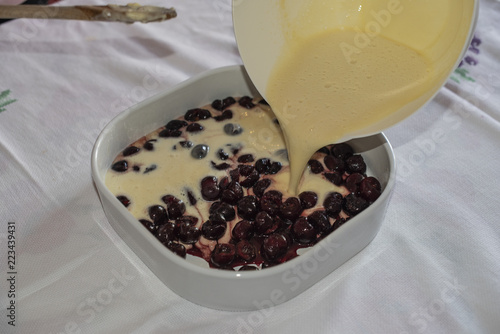 Clafoutis with Cherry. Red and ripe cherries. Preparation and close-up.