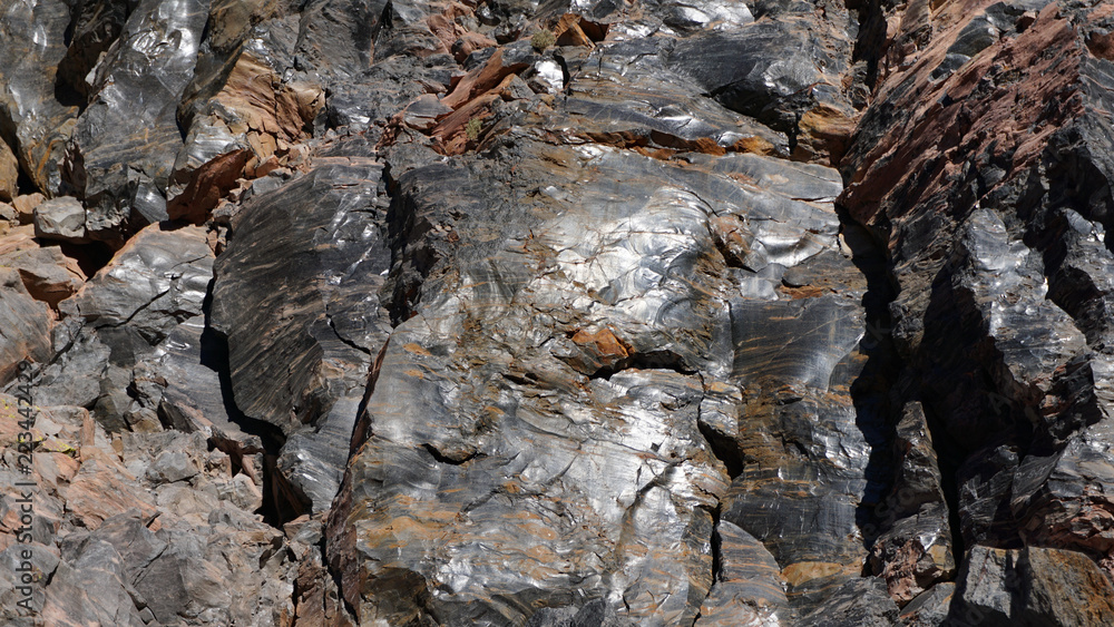 Sunlight reflects from the shiny surface of a volcanic glass rock at Obsidian Dome, hardened blocks of lava from a volcano in the eastern Sierra Nevada mountains of California Sunlight reflects from the shiny surface of a volcanic glass rock at Obsidian Dome, hardened blocks of lava from a volcano in the eastern Sierra Nevada mountains of California