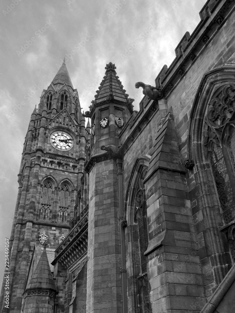 monochrome image of the historic rochdale town hall in lancashire a historic gothic building with tall clock tower ornate stone carvings and gargoyles