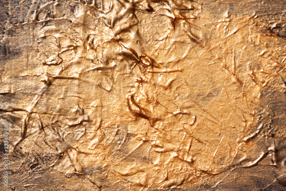 Gold is a bright shiny texture of dried paint.