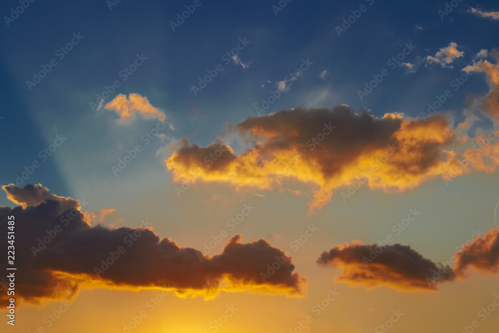 Clouds at sunset with a jet