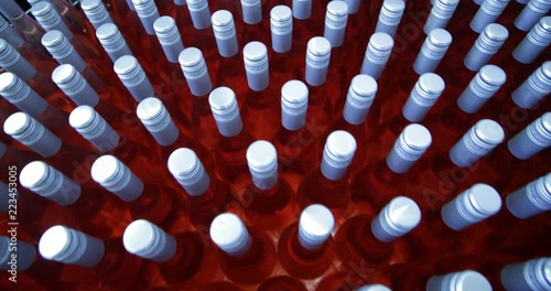 Detail of group of pink wine bottles in metal bascket. Storage stage ready for send away. Beverage production industry. Mendoza, Argetnina