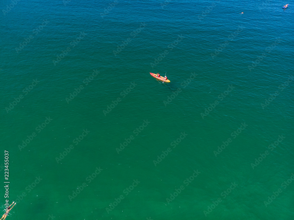  Aerial photo double canoe drone in crystal clear green sea water