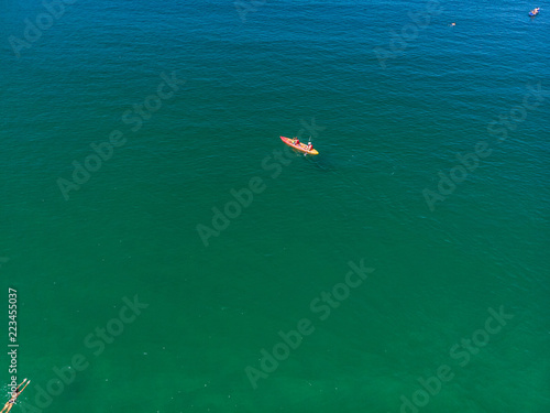  Aerial photo double canoe drone in crystal clear green sea water