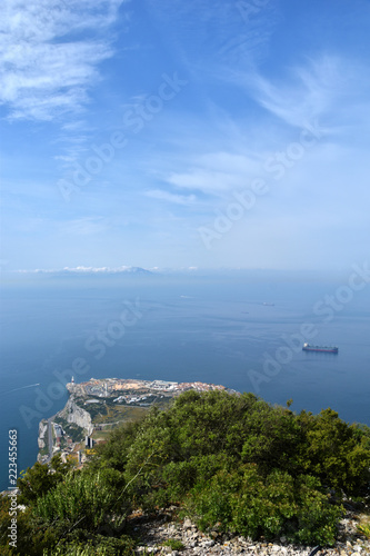 Panoramic vista view overlooking the Mediterranean Sea, Africa, and container ship with blue skies.