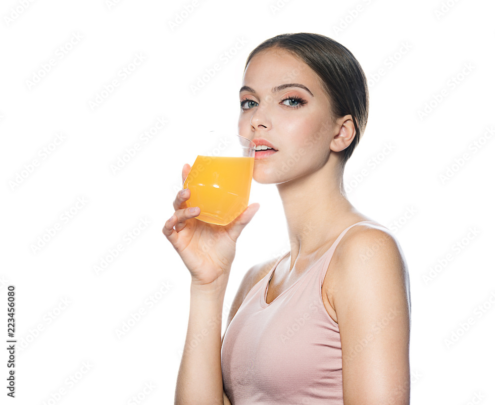 head and shoulders portrait of attractive young caucasian woman isolated on white studio shot drinking orange juice face skin klookıng at camera head and shoulders portrait of attractive young caucasian woman isolated on white studio shot drinking orange juice face skin klookıng at camera