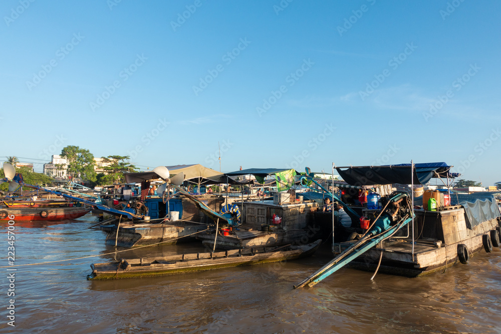 Tourists, people buy and sell food, vegetable, fruits on vessel, boat, ship in Cai Rang floating market, Mekong River. Royalty stock image of traffic on the floating market or river market in Vienam