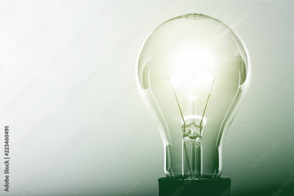 Glowing glass light bulb, close-up view Glowing glass light bulb, close-up view