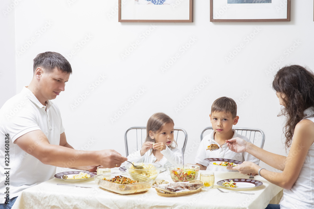 Family Concepts and Ideas of Combined Eating. Happy Parents with Their Children Having Breakfast at Home Together Family Concepts and Ideas of Combined Eating. Happy Parents with Their Children Having Breakfast at Home Together