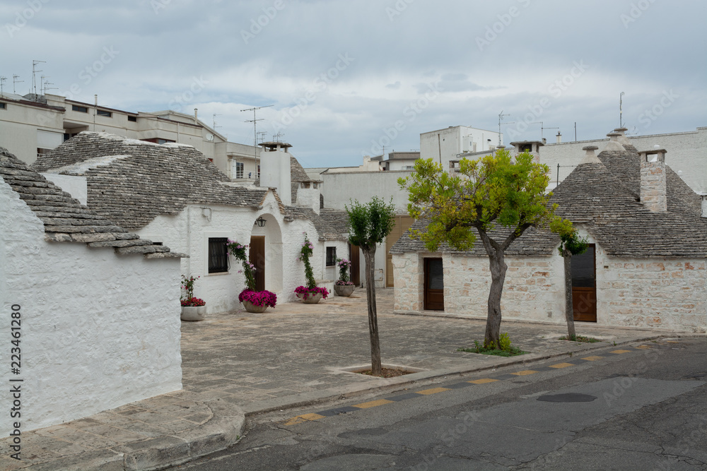 Unique small South Italia city Alberobello with antient stones conical houses trullo, tourist destination
