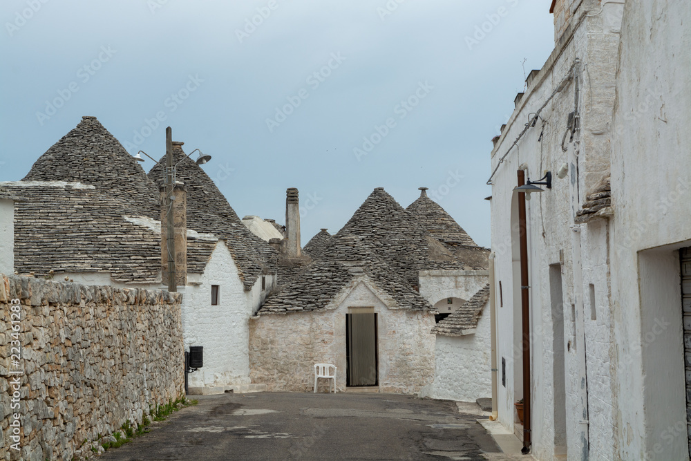 Unique small South Italia city Alberobello with antient stones conical houses trullo, tourist destination