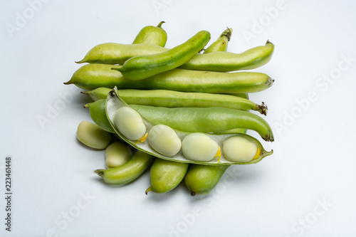 New harvest of healthy vegetables, green fresh raw big broad beans close up isolated on white background