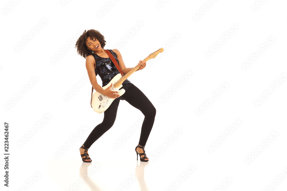 Millennial female musician playing electric guitar isolated on white backdrop Millennial female musician playing electric guitar isolated on white backdrop