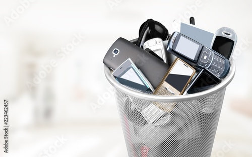 Rubbish bin full of old cellphones