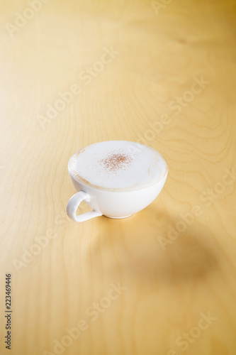 hot cappuccino on the wooden table