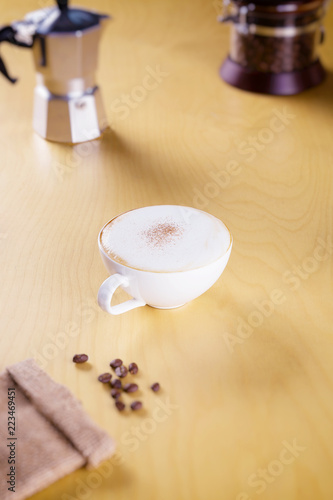 hot cappuccino on the wooden table