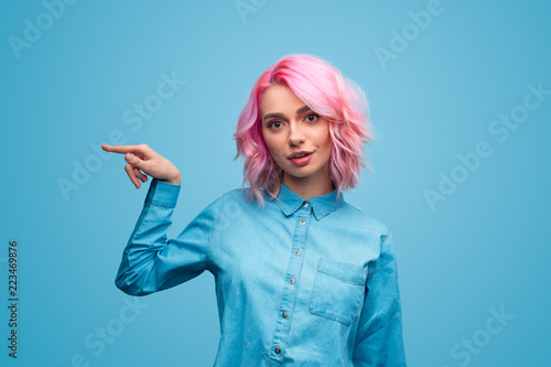 Crazy young woman pointing aside