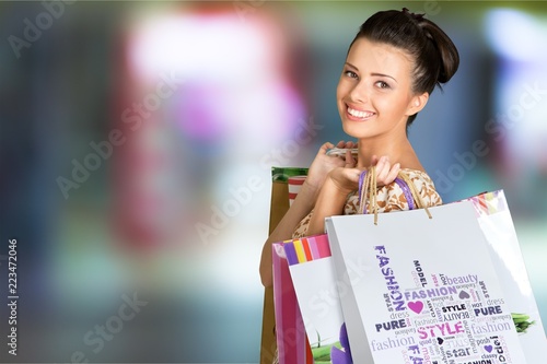 Young woman with shopping bag on blurred