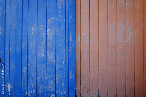 Orange and blue wooden wall background © jaykoppelman